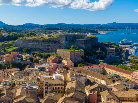 Coastal town with ancient fortress overlooking harbor