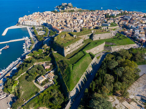 Aerial view of a coastal city with a large fortress and harbor. - Powered by Adobe