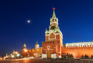 The Kremlin with the Spasskaya Tower on Red Square on a winter moonlit night. Moscow, Russia