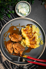 Stewed turkey meat served with sauce and mashed potatoes.