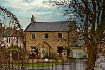 Two-Story Stone House with Detached Garage and Fence in Knaresborough, UK.