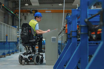 Production line engineer with disability in a factory with yellow vest and blue helmet at work.