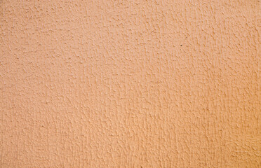 Concrete wall with decorative brown plaster.