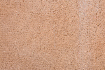 Abstract brown plaster background on concrete wall.