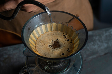 Pour hot water over the coffee powder. Make drip coffee. © jordan
