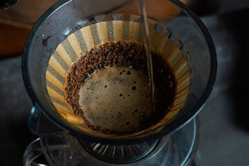 Pour hot water over the coffee powder. Make drip coffee © jordan