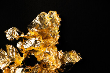 An abstract composition of crumpled metallic foil, bathed in gold hues. It evokes icy textures and...