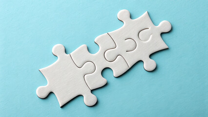 Obraz premium Three white puzzle pieces are connected against a light blue background. Their simple forms stand out, emphasizing the concept of fitting together. AI generated.