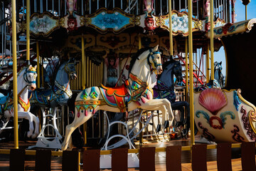 Carousel with colorful horses, Merry go round with horse, Vintage ride attraction for children © nvphoto