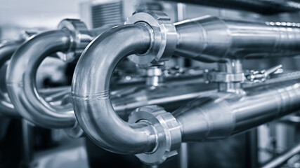 Stainless steel pipes in the factory. Construction on food production, Abstract industry background.