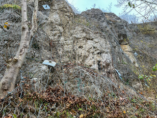 Protection of a rocky slope with a metal net against falling broken stones