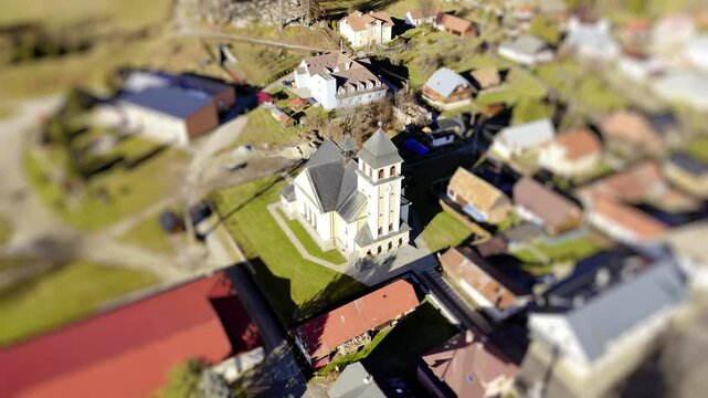 Aerial Tilt-Shift View of a Church in a Quaint Village Landscape with Rotating view