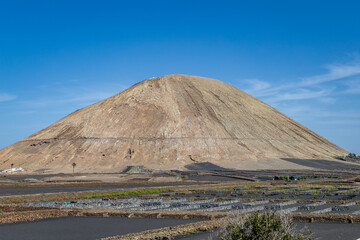 Photo of an old volcanic cone in Lanzarote in the  Canary Islands in Spain on a clear day