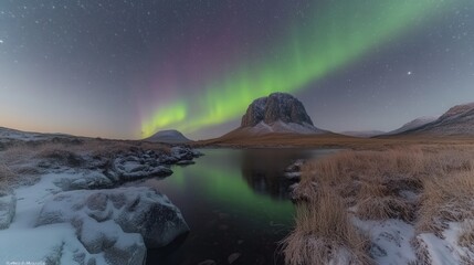 Stunning Aurora Borealis Over Icy Mountain Landscape with Vibrant Northern Lights Reflecting on River at Night in Winter Wilderness