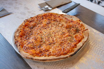margherita pizza with cheese and artisanal tomato sauce in an angled table restaurant