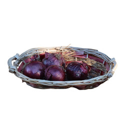 Fresh red onions resting in a rustic wicker basket with transparent background