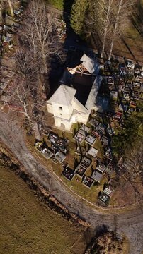 Vertical Aerial View of an Old Church in the Middle of a Cemetery in Rural Landscape, 