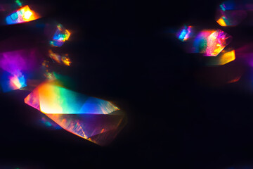 Blur colorful warm rainbow crystal light leaks on black background. Defocused abstract retro film analog effect for using over photos as overlay or screen filter