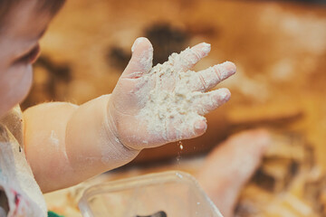Little child making cookies at home. Close-up