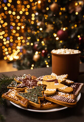 Lots of gingerbread cookies for Christmas in a plate on a dark background. Homemade gingerbread cookies for Christmas holiday.