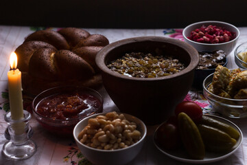 Traditional Christmas Eve food: kutia in a clay pot, dumplings, stuffed cabbage, beans and other lean dishes