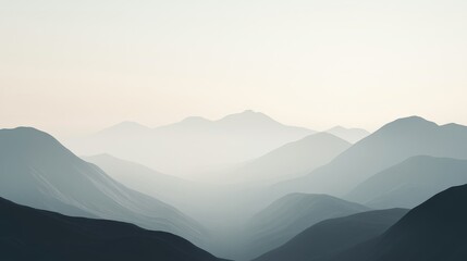 Misty mountains fade into the distance at dawn.