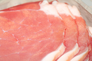 CLose Up of Raw Uncooked Bacon Slices Ready to be Cooked