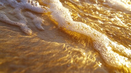 Obraz premium Golden sandy beach at sunset with soft ocean waves gently lapping the shore creating a tranquil and serene coastal atmosphere