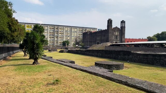 Ruins of Tlatelolco at Plaza de Las Tres Culturas, or Three Cultures square, backgrounded by the Temple of Santiago in Mexico City, Mexico.