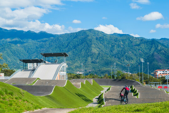 Stunning BMX Track with a Backdrop of Green Mountains and Clear Skies