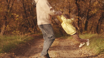 happy family park. father circling little child daughter his arms autumn park. kid with dad dreams...