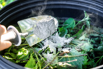 Making Nettle Manure with Rock Dust / Process of adding mineral-rich rock dust to fermenting nettle...