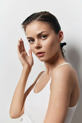 portrait, beauty, confidence, natural light, young woman, calm expression, minimalistic background, understated elegance, soft features, lifestyle photography