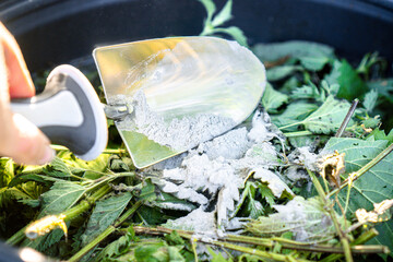 Making Nettle Manure with Rock Dust / Process of adding mineral-rich rock dust to fermenting nettle...