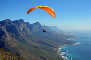 Stunning paragliding adventure above majestic mountains under a clear sky in daylight