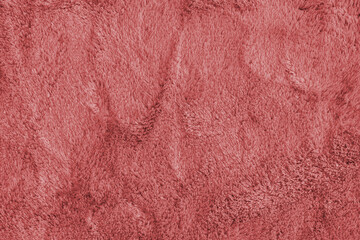 Soft shaggy red carpet texture. Fluffy synthetic textile fur, plush textile, blanket cloth background. Wallpaper, backdrop, solid color