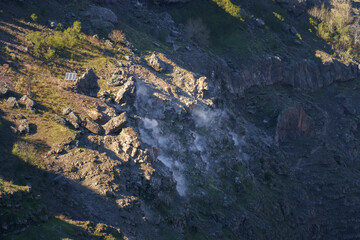 Steam emissions from fumaroles on the rocky slopes of Mount Vesuvius, an active volcano near...
