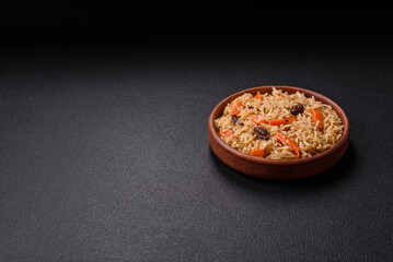 Delicious fresh pilaf with rice, carrots, meat, onions, spices and berries