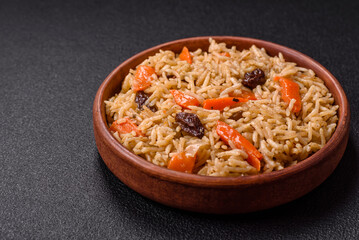 Delicious fresh pilaf with rice, carrots, meat, onions, spices and berries