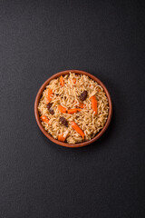 Delicious fresh pilaf with rice, carrots, meat, onions, spices and berries