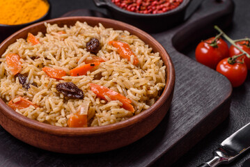 Delicious fresh pilaf with rice, carrots, meat, onions, spices and berries