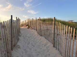 Beach sunset walk with fence in Southampton NY