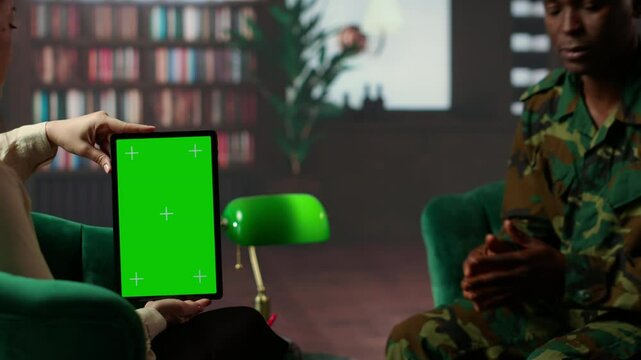 Black army soldier crying at therapy session next to chroma key screen, seeking professional support for PTSD and trauma recovery. Discussions for armed forces mental health care. Camera B.