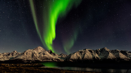 Northern Lights over Snowy Mountains