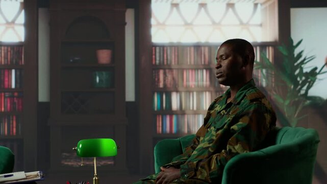 African american military trooper sharing flashbacks from the war during counseling session, tying to cure PTSD and shell shock. Army veteran deals with depression after traumatic scenes. Camera B.