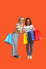 Beautiful young women in sunglasses with shopping bags on orange background