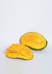 Yellow ripe mango slices isolated on white background.Copy space for text.Source of vitamin c.Fresh fruit concept.Mango sliced in squares.For graphic design or banner background