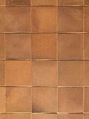 Top view of reddish brown rustic natural stoneware outdoor floor. Classic rough anti-slip matte terracotta ceramic square tiles for paving, terrace, porch, patio, pool exterior texture background.
