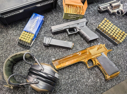 Baltics, December 28, 2024 - On a shooting range table in one of the Baltic countries, an arsenal of a modern shooter is laid out: a powerful Desert Eagle, a practical Glock, a magnum revolver.