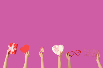 Women with gifts, credit card and decor on purple background. Valentine's Day celebration